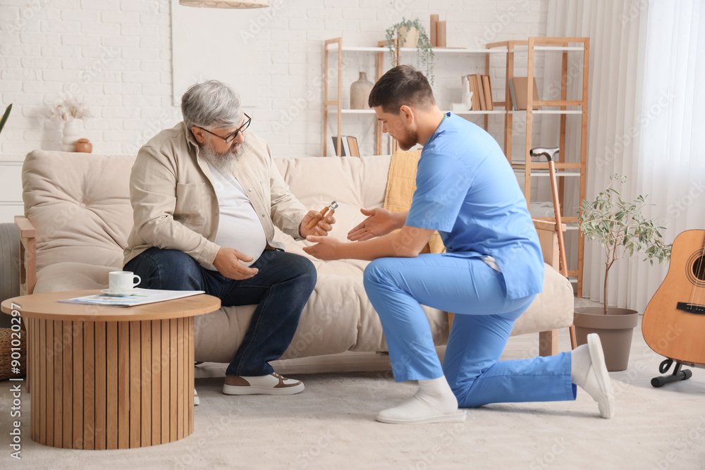 Young caregiver and senior man with hand expander at home Young caregiver and senior man with hand expander at home