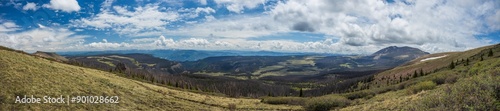 Mountain tundra panorama overlooking forest valley