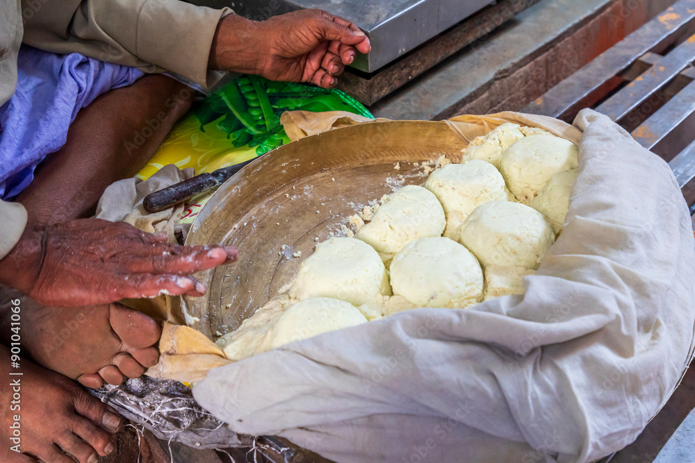 India, Uttar Pradesh, Varanasi, Lahori Tola. Preparing balls of chhena, a sweet dessert.