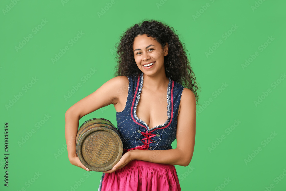 Happy African-American woman with barrel of beer on green background. Octoberfest celebration Happy African-American woman with barrel of beer on green background. Octoberfest celebration