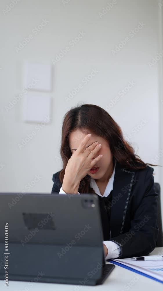 Asian businesswomen, tired, stressed office workers, headaches over delayed work hours. Body aches, discomfort, work not being accomplished according to the set goals. Office syndrome concept. Asian businesswomen, tired, stressed office workers, headaches over delayed work hours. Body aches, discomfort, work not being accomplished according to the set goals. Office syndrome concept.