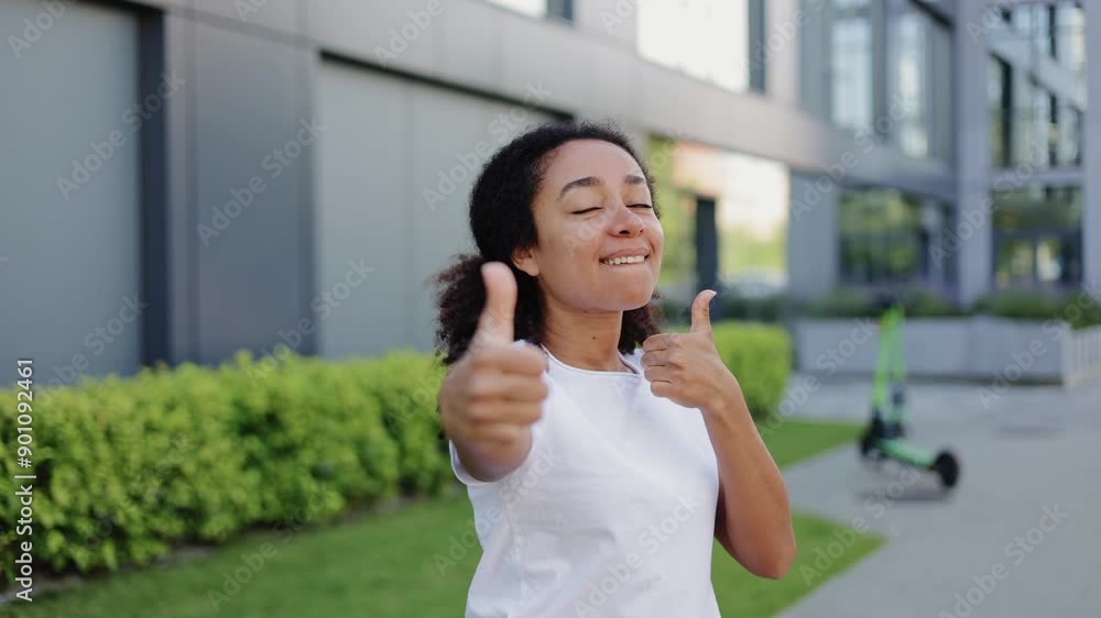 Rejoiced hispanic female in white clothes jumping on one place and showing double thumbs up gesture to camera. Successful lady with dark hair choosing best option and approving good quality. Rejoiced hispanic female in white clothes jumping on one place and showing double thumbs up gesture to camera. Successful lady with dark hair choosing best option and approving good quality.