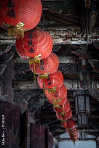 Foto Red lanterns hanging on a wooden ceiling