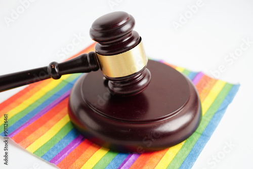 Gavel for judge lawyer on rainbow flag, symbol of LGBT pride month. photo