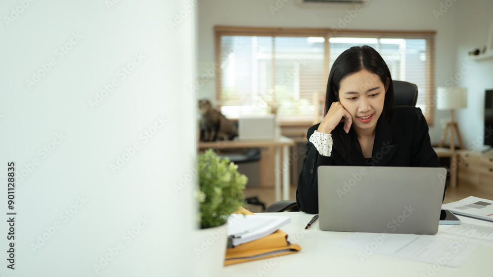 Portrait of charming young businesswoman working on laptop in home office Portrait of charming young businesswoman working on laptop in home office