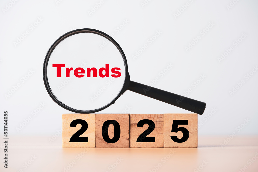 Magnifier glass with trends on 2025 for focusing business technology and fashion marketing change after new year concept. Magnifier glass with trends on 2025 for focusing business technology and fashion marketing change after new year concept.