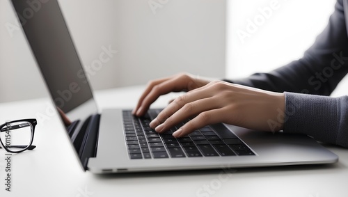 person typing on a laptop. office environment