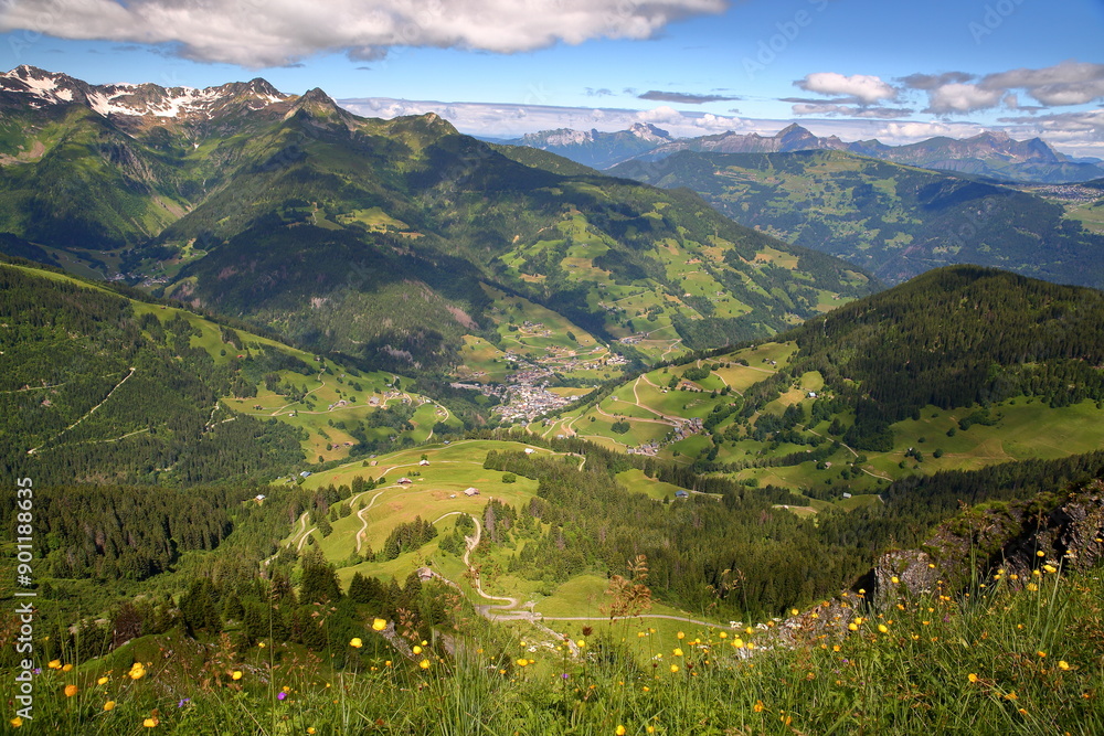 The valley of Areches, Beaufort, Beaufortain, Savoie, France, surrounded by mountain pastures and mountains, and viewed from a hiking trail on a ridge leading to Roche Parstire