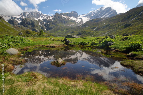 The valley of the petite Sassiere, Sainte Foy Tarentaise, Northern French Alps, Savoie, France, with the hamlet Sassiere and reflection of mountains (Invernet peak and Becca du Lac)