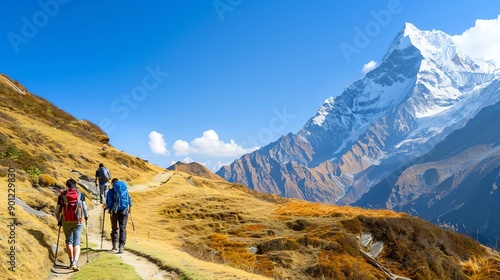 A group of hikers trekking on a scenic mountain trail with stunning peaks and clear blue skies.