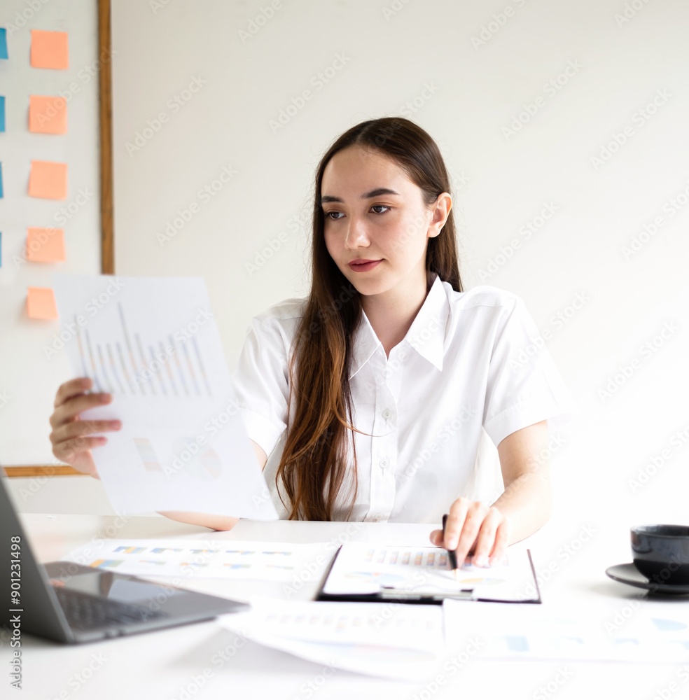 Asian businesswoman calculate financial graphs showing results about their investments, plan a successful business growth process Asian businesswoman calculate financial graphs showing results about their investments, plan a successful business growth process