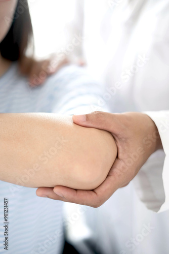 Female physiotherapists provide physical assistance to women patients with elbow injuries examine patients in rehabilitation centers. Physiotherapy concepts