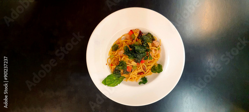 Spaghetti with Tomato Sauce and minced pork  in white plate on black background