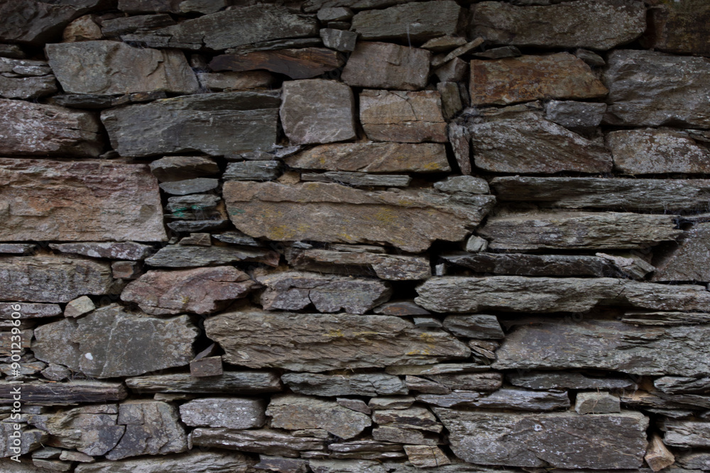 Weathered stone wall architectural detail. Ancient historical stone wall. Stone structure background texture for design and montage purposes. Weathered stone wall architectural detail. Ancient historical stone wall. Stone structure background texture for design and montage purposes.