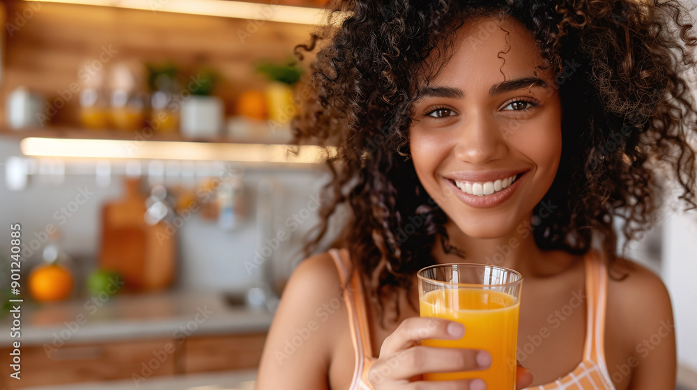 Smiling curly woman with apple fresh natural juice in kitchen Smiling curly woman with apple fresh natural juice in kitchen