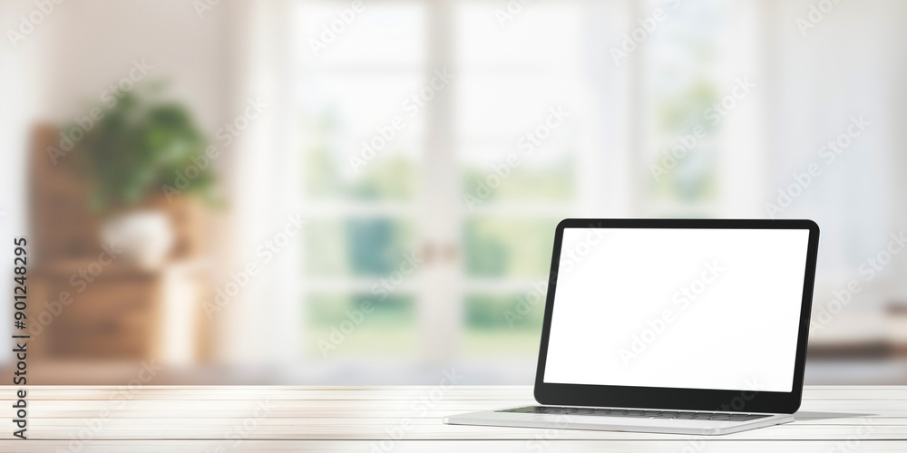 A laptop with a blank screen sits on desk blur background. A laptop with a blank screen sits on desk blur background.