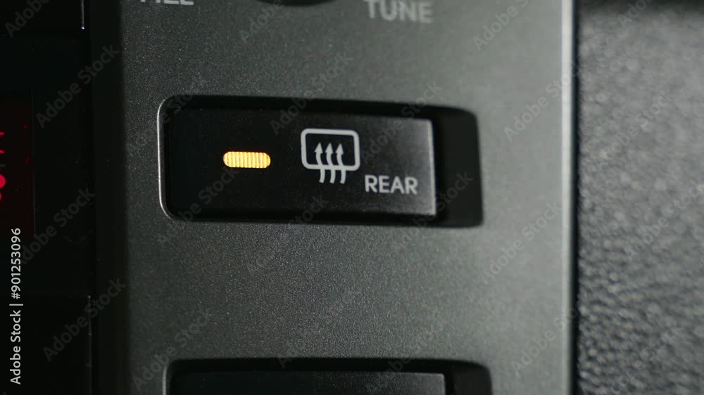 Window Defroster Buttonm A close-up view of a rear window defroster button inside a car. The ...