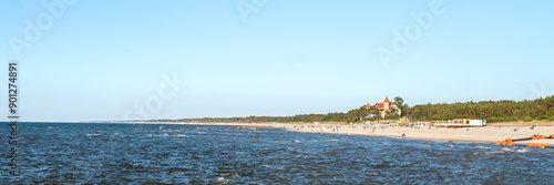 Obraz na płótnie View of the beach in Leba. Beautiful wide beach on a sunny day. Castle and people in the distance. Leba, Poland w salonie