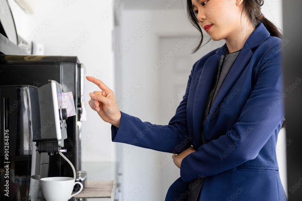 Businesswoman sitting at desk on couch in workplace or at home working on laptop and analyzing data on charts and graphs and writing on papers to make business plan Businesswoman sitting at desk on couch in workplace or at home working on laptop and analyzing data on charts and graphs and writing on papers to make business plan