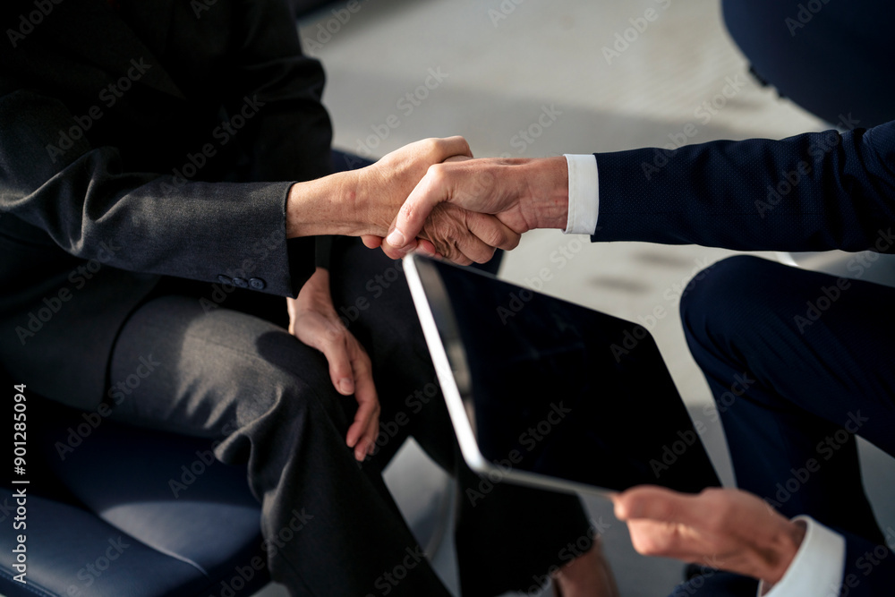 © Westend61 - Business colleagues doing handshake at office