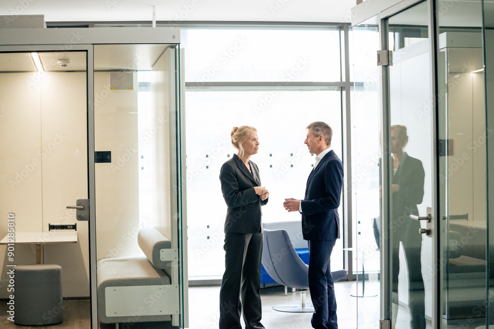 Business colleagues discussing together at work place Business colleagues discussing together at work place