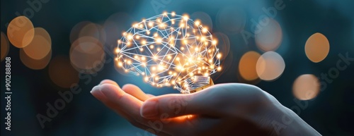 A glowing representation of a brain in a hand, symbolizing creativity, innovation, and the connection between technology and human thought.