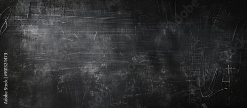 An abstract blackboard with chalk marks is ideal as a background for adding text or graphics due to the ample copy space image it offers