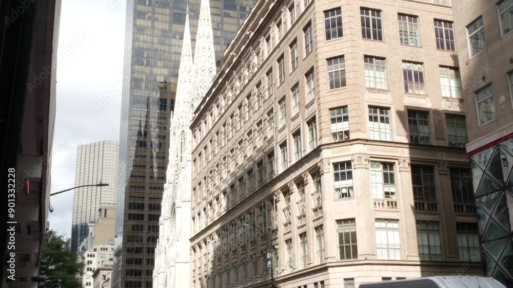 Fototapeta premium New York City Manhattan Midtown building architecture, urban street in United States. 5th Fifth 5 avenue residential and business property. St Patricks cathedral on rainy day. American Catholic church