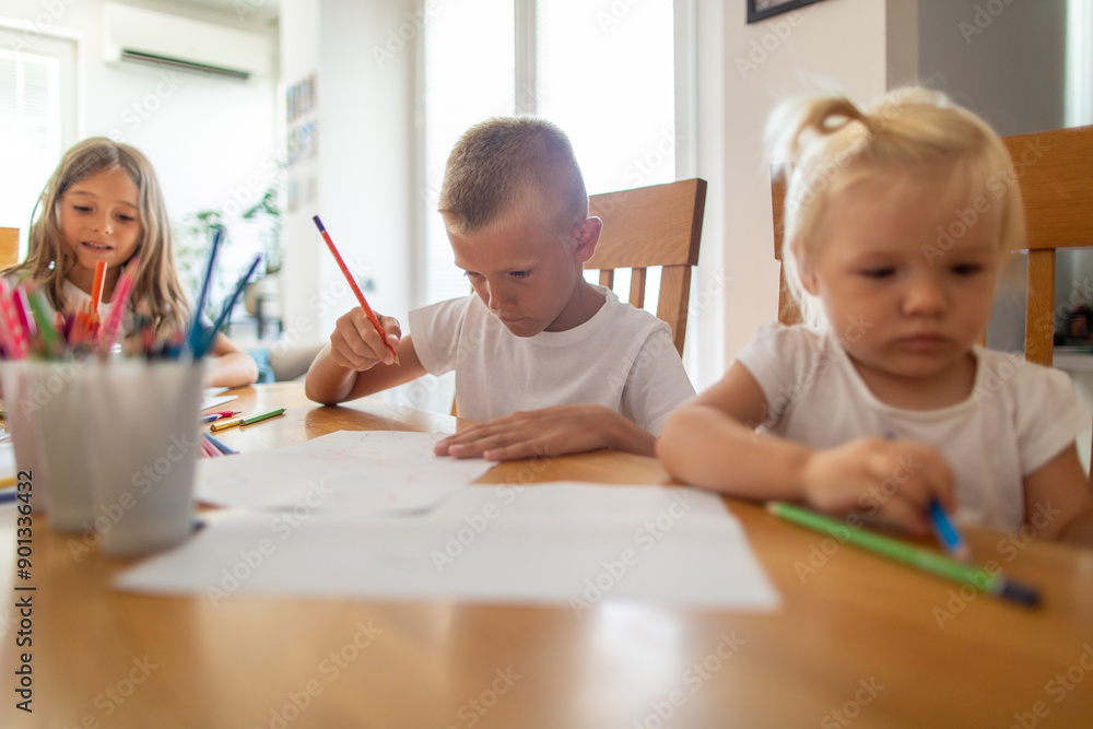 Shot of three kids drawing together at home Shot of three kids drawing together at home