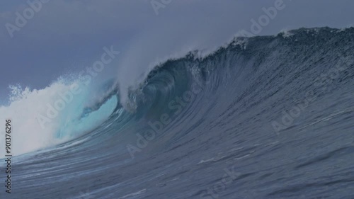 Crashing ocean wave creates small picturesque barrel with heavy shoulder, Cloudbreak Fiji photo