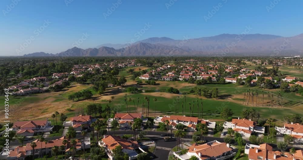 Golf course community with bright green fairways in Palm Springs California USA, aerial establish Golf course community with bright green fairways in Palm Springs California USA, aerial establish