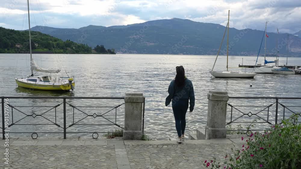 Tourist Visiting Lakeside Town Of Laveno-Mombello In Varese Province, Lake Maggiore, Lombardy, Italy. Static Shot Tourist Visiting Lakeside Town Of Laveno-Mombello In Varese Province, Lake Maggiore, Lombardy, Italy. Static Shot