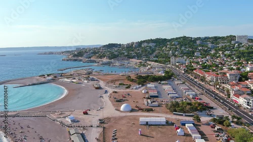 Marseille, France: Aerial view of Marina Olympique, main marina for Olympic Summer Games Paris 2024, flags of participating states flutter in wind - landscape panorama of Europe from above
 photo