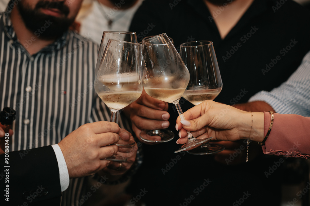 We celebrate the evening with white wine and roses in glasses, giving cheers at a restaurant, relaxed and full of joy. We celebrate the evening with white wine and roses in glasses, giving cheers at a restaurant, relaxed and full of joy.