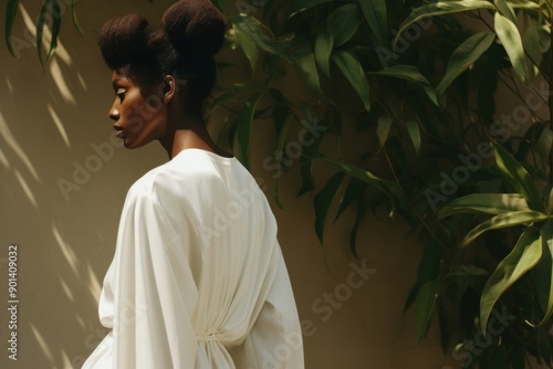 A black woman wearing white modern minimal cloth fashion photography portrait. photo