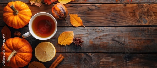 Autumn themed still life with tea lemon pumpkins leaves on dark wooden table embodies fall mood for Thanksgiving and Halloween with flat lay setting and room for copy space image