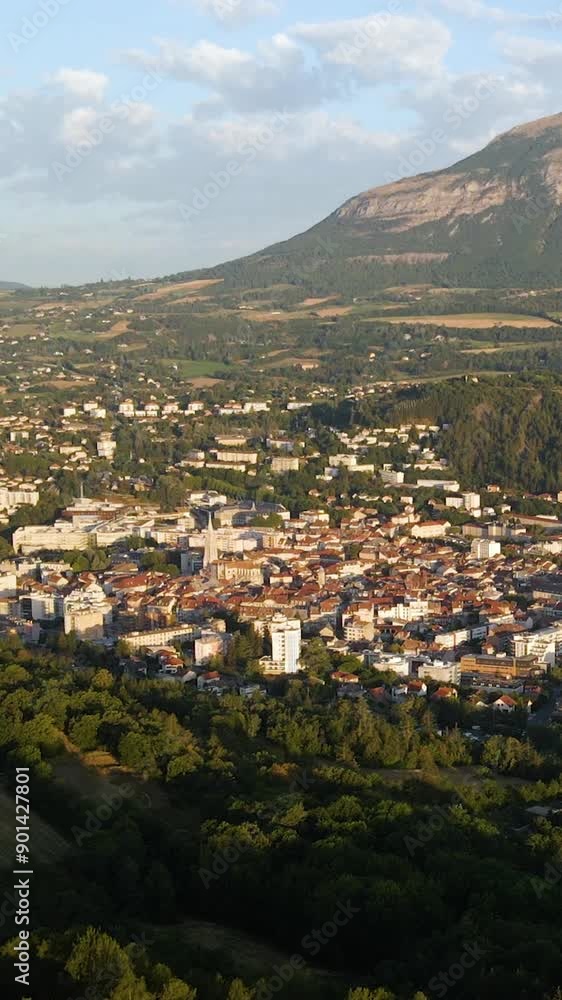 Summer morning aerial view of the City of Gap, capital of Hautes-Alpes department, with the Charance mountain. French Alps, France Summer morning aerial view of the City of Gap, capital of Hautes-Alpes department, with the Charance mountain. French Alps, France