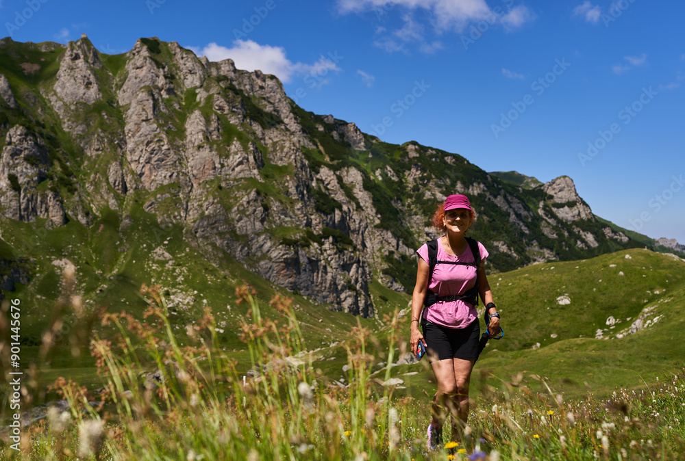 Woman hiker with poles and backpack Woman hiker with poles and backpack