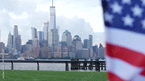 New York City waterfront skyline, Manhattan Downtown World Trade Center skyscraper. Cityscape from New Jersey, United States. American flag 11 September, USA. Independence and Remembrance symbol. Wind