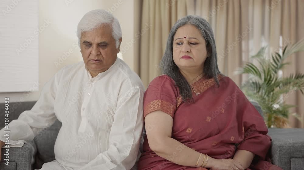 Angry Old Indian couple sitting back to back Angry Old Indian couple sitting back to back