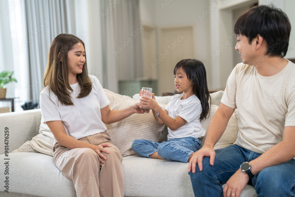 Portrait of enjoy happy love asian family father and mother with little asian girl smiling and having protein breakfast drinking and hold glasses of milk at home Portrait of enjoy happy love asian family father and mother with little asian girl smiling and having protein breakfast drinking and hold glasses of milk at home