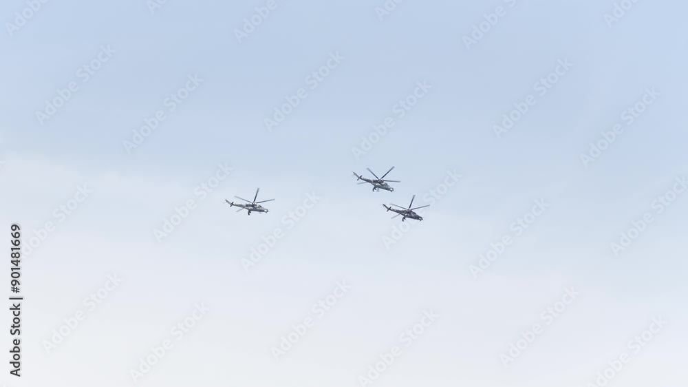 Battle helicopters fly past - bottom view from the ground Battle helicopters fly past - bottom view from the ground
