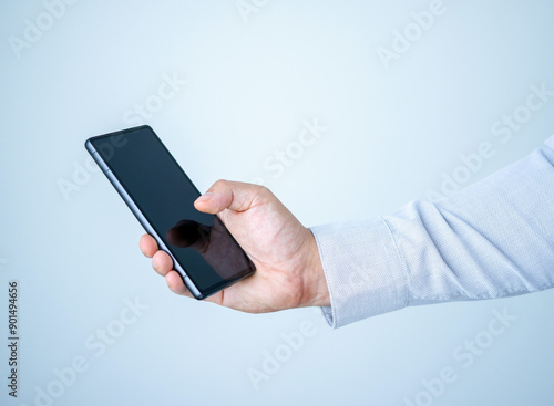 Hand holding mobile phone, smart phone, business casual, wearing shirt, bright background