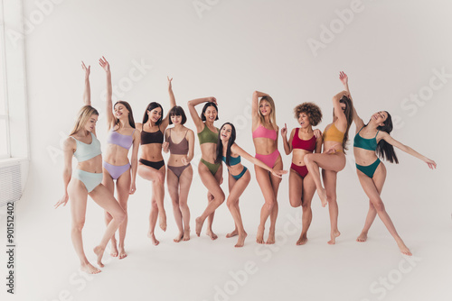 Full length no filter studio photo of funny adorable women wear underwear having fun enjoying girls power isolated beige color wall background