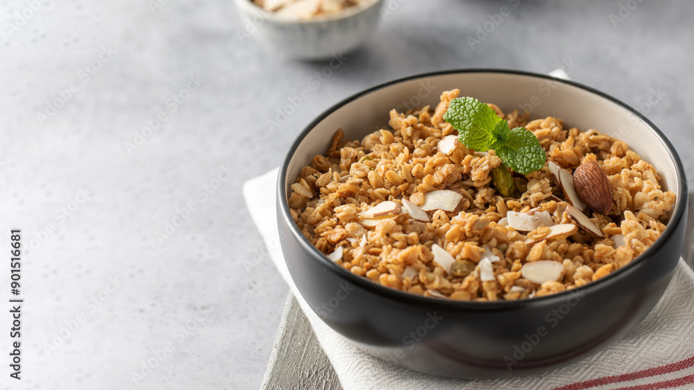 Crispy homemade granola with sliced almonds in a bowl. Healthy food. Copy space Crispy homemade granola with sliced almonds in a bowl. Healthy food. Copy space