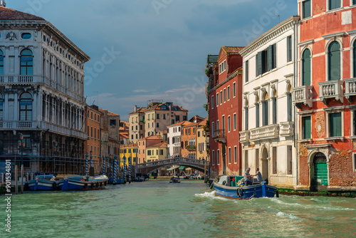 Venice, Italy - June 04, 2024: "Classical Venetian Buildings Along the Canal with Boats Floating on the Water.