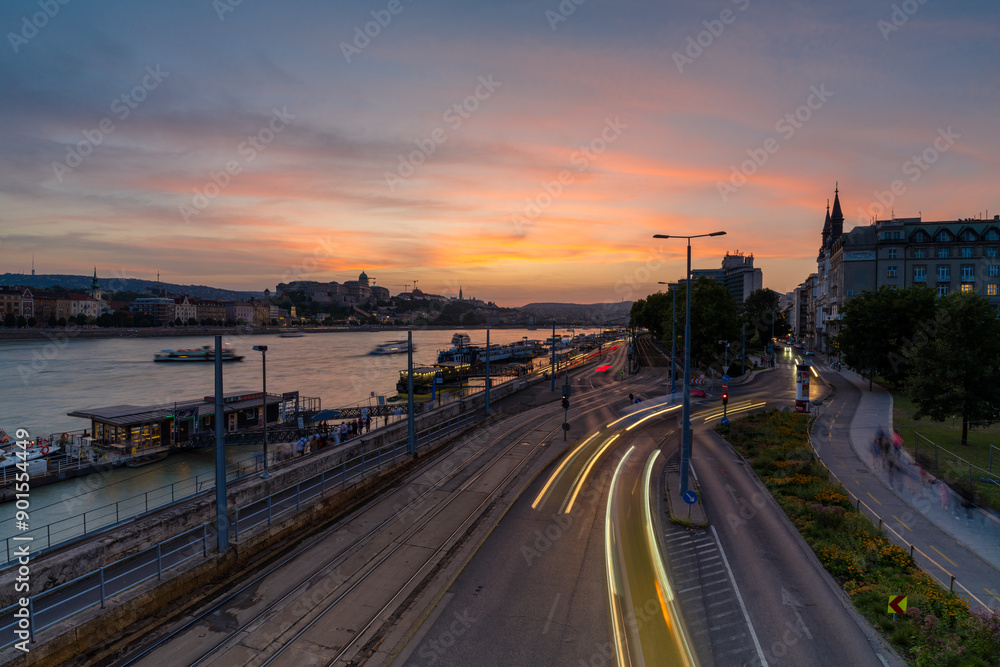 Budapest, Hungary: July 09, 2024: Cityscape sunset view from Elisabeth Bridge. Jane Haining street of the foreground. Buda castle on the background. Budapest, Hungary: July 09, 2024: Cityscape sunset view from Elisabeth Bridge. Jane Haining street of the foreground. Buda castle on the background.