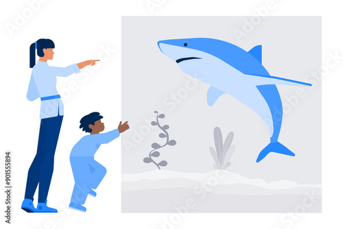Woman and boy looking at a shark in aquarium