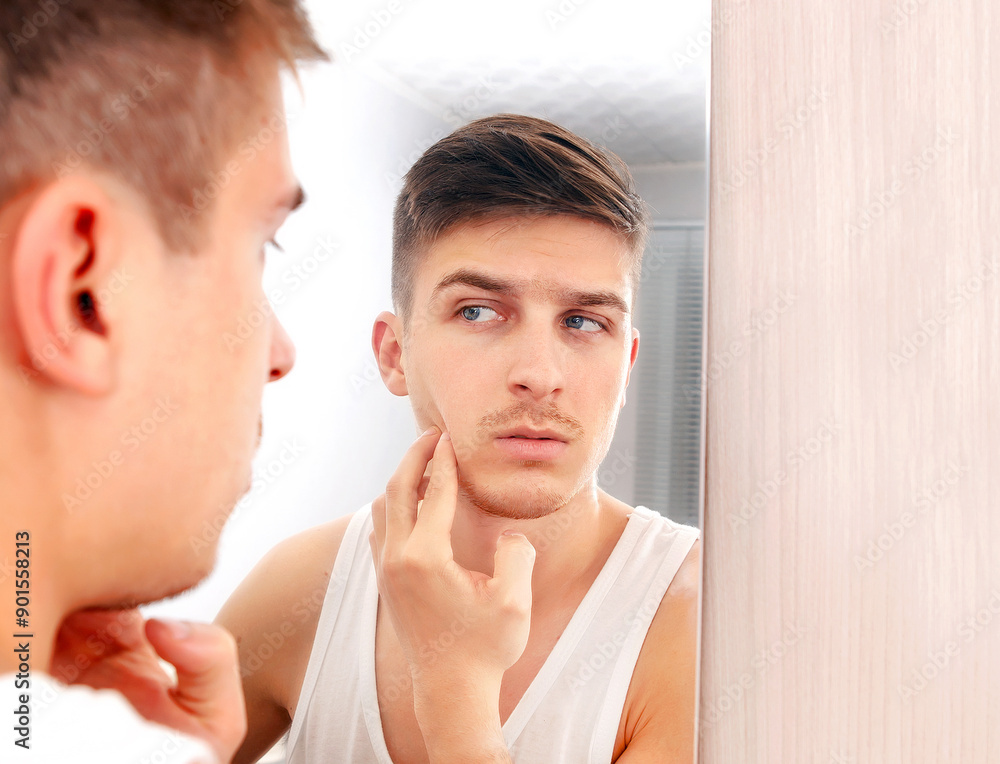 Fototapeta premium Young Man near a Mirror