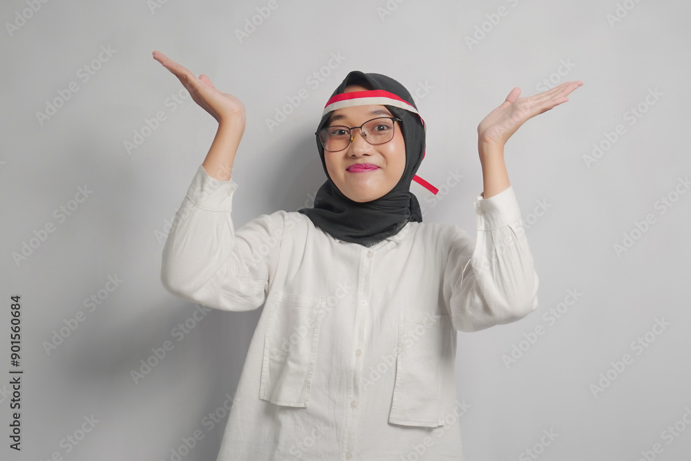 Smiling Woman in Hijab with Hands Raised in a White Shirt Smiling Woman in Hijab with Hands Raised in a White Shirt